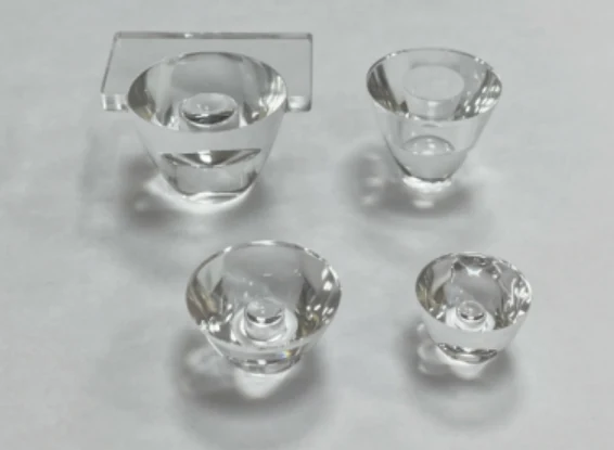 Compact glass TIR lens examples with entrance cavities and shaped exits